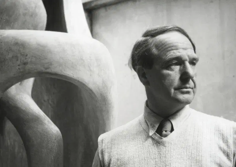 Henry Moore, in front of one of his sculptures.